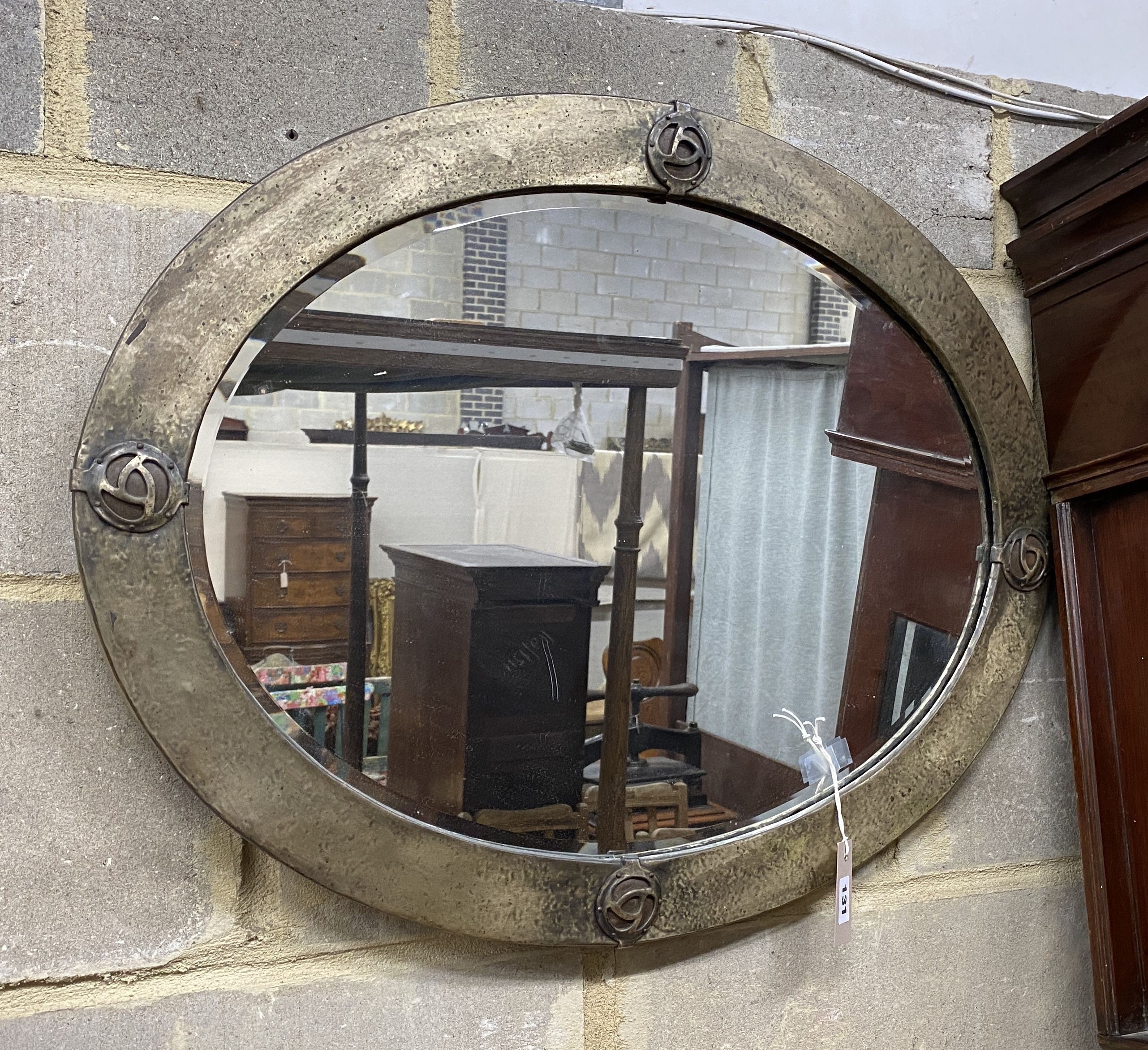 An Art Nouveau style oval metal framed wall mirror, width 70cm, height 54cm